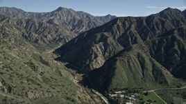 5K aerial stock footage approach road at the base of green ridges in the San Gabriel Mountains, California Aerial Stock Footage | AX0009_008