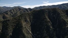 5K aerial stock footage fly over sharp ridge and approach green mountains of the San Gabriel Mountains, California Aerial Stock Footage | AX0009_029