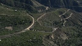 5K aerial stock footage approach and tilt to curved roads in the San Gabriel Mountains, California Aerial Stock Footage | AX0009_040