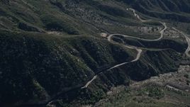 5K aerial stock footage orbit road at the base of slopes in the San Gabriel Mountains, California Aerial Stock Footage | AX0009_042