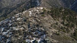 5K aerial stock footage fly over ridge with snow on shady side in the San Gabriel Mountains in winter, California Aerial Stock Footage | AX0009_053E
