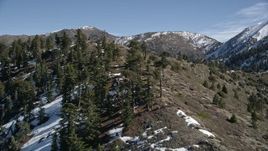 5K aerial stock footage of a snowy ridge in winter and tilt up in the San Gabriel Mountains, California Aerial Stock Footage | AX0009_055E