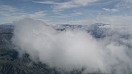 5K aerial stock footage of approaching and flying over a cloud over the San Bernardino Mountains, California Aerial Stock Footage | AX0009_075E
