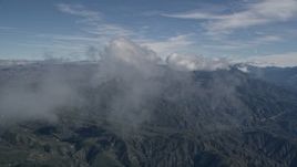 5K aerial stock footage fly through wispy clouds over the San Bernardino Mountains, California Aerial Stock Footage | AX0009_077E