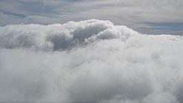 5K aerial stock footage of fluffy clouds over San Bernardino County, California Aerial Stock Footage | AX0009_099E