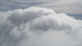 5K aerial stock footage fly over thick clouds to reveal summit of San Bernardino Mountains peak, California Aerial Stock Footage | AX0009_101