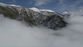 5K aerial stock footage of approaching San Bernardino Mountains ridge with winter snow, California Aerial Stock Footage | AX0009_113