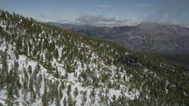 5K aerial stock footage fly over mountain slope covered in winter snow and evergreens, San Bernardino Mountains, California Aerial Stock Footage | AX0009_122
