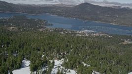5K aerial stock footage fly over the top of a mountain to reveal Big Bear Lake, San Bernardino Mountains, California Aerial Stock Footage | AX0009_128E