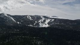 5K aerial stock footage of Snow Summit ski slopes with winter snow, California Aerial Stock Footage | AX0009_142