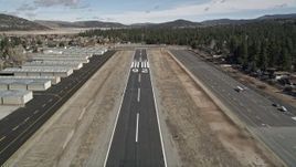 5K aerial stock footage liftoff from the eunway at Big Bear City Airport, California Aerial Stock Footage | AX0010_001