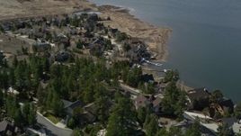 5K aerial stock footage of orbiting lakefront homes with light snow patches at Big Bear Lake, California Aerial Stock Footage | AX0010_013