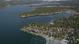 5K aerial stock footage tilt to waterfront homes on the shore of Big Bear Lake in winter, California Aerial Stock Footage | AX0010_030
