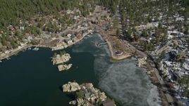 5K aerial stock footage approach waterfront homes and the town on the shore of Big Bear Lake in winter, California Aerial Stock Footage | AX0010_031