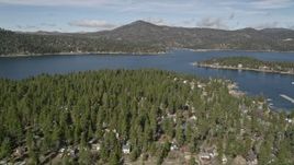 5K aerial stock footage of Big Bear Lake seen from town on the shore in winter, California Aerial Stock Footage | AX0010_032