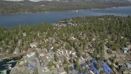 5K aerial stock footage tilt and approach homes and town on the shore of Big Bear Lake, California Aerial Stock Footage | AX0010_033E
