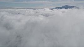 5K aerial stock footage approach clouds and a tall San Jacinto Mountains peak in the distance, California Aerial Stock Footage | AX0010_073