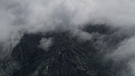 5K aerial stock footage of bird's eye view of San Jacinto Mountains below layer of clouds, California Aerial Stock Footage | AX0010_075