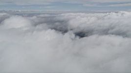 5K aerial stock footage of orbiting above thick cloud cover in Southern California Aerial Stock Footage | AX0010_076