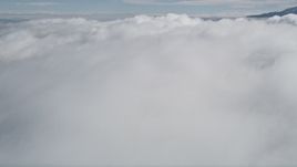 5K aerial stock footage tilt up and fly over thick cloud cover in Southern California  Aerial Stock Footage | AX0010_077