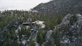 5K aerial stock footage of circling a mountain tram station in the San Jacinto Mountains with winter snow, California Aerial Stock Footage | AX0010_109E