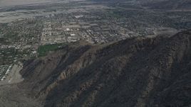 5K aerial stock footage orbit West Palm Springs suburban neighborhoods seen from the mountains, California Aerial Stock Footage | AX0010_129