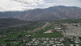 5K aerial stock footage of suburban neighborhoods in West Palm Springs near tall mountain range, California Aerial Stock Footage | AX0010_142