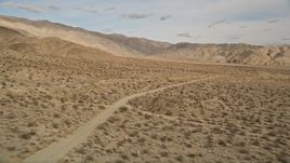 5K aerial stock footage approach and orbit a lonely dirt road in Joshua Tree National Park, California Aerial Stock Footage | AX0011_011