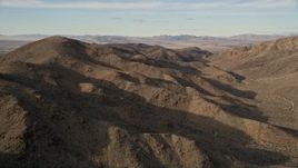 5K aerial stock footage of flying along desert mountains, Mojave Desert, California Aerial Stock Footage | AX0011_051