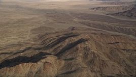 5K aerial stock footage tilt down to desert mountains, Mojave Desert, California Aerial Stock Footage | AX0011_058