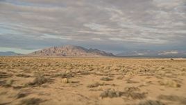 5K aerial stock footage fly over desert vegetation toward mountains, Mojave Desert, California Aerial Stock Footage | AX0012_003