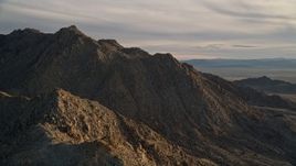 5K aerial stock footage orbiting a desert mountain peak, Mojave Desert, California, sunset Aerial Stock Footage | AX0012_046