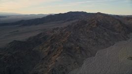 5K aerial stock footage fly by a desert mountain range, Mojave Desert, California, sunset Aerial Stock Footage | AX0012_050