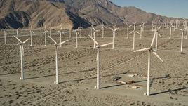 5K aerial stock footage of flying by rows of windmills, San Gorgonio Pass Wind Farm, California Aerial Stock Footage | AX0013_020E