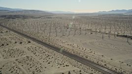 5K aerial stock footage fly over windmills, orbit railroad tracks, San Gorgonio Pass Wind Farm, California Aerial Stock Footage | AX0013_026E
