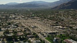 5K aerial stock footage fly over apartment buildings toward residential road, Palm Springs, California Aerial Stock Footage | AX0013_033E