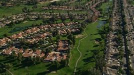 5K aerial stock footage of condominiums surrounded by a golf course, Palm Desert, California Aerial Stock Footage | AX0013_070