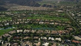 5K aerial stock footage tilt to upscale homes surrounded by a golf course, Indian Wells, California Aerial Stock Footage | AX0013_075