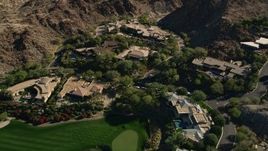 5K aerial stock footage of mansions at the base of a mountain, Indian Wells, California Aerial Stock Footage | AX0013_080