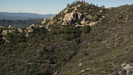 5K aerial stock footage video fly over a rocky peak to reveal Mountain Center, San Jacinto Mountains, California Aerial Stock Footage | AX0014_012