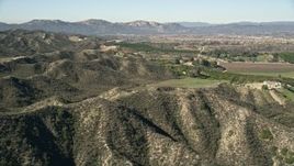 5K aerial stock footage fly over hills toward farmland, Temecula, California Aerial Stock Footage | AX0014_033