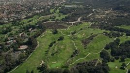 5K aerial stock footage video fly by greens at a golf course, Temecula, California Aerial Stock Footage | AX0015_002