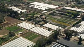 5K aerial stock footage of orbiting farmland and greenhouse, Fallbrook, California Aerial Stock Footage | AX0015_009