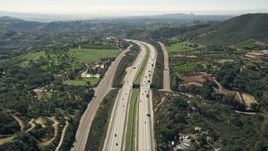 5K aerial stock footage of following interstate with light traffic through the country, Fallbrook, California Aerial Stock Footage | AX0015_011