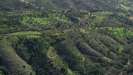 5K aerial stock footage of flying over hills toward farmland, Fallbrook, California Aerial Stock Footage | AX0015_015