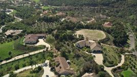 5K aerial stock footage fly by large homes in the hills, Fallbrook, California Aerial Stock Footage | AX0015_025