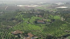 5K aerial stock footage of large homes and farmland atop a hill, Fallbrook, California Aerial Stock Footage | AX0015_035