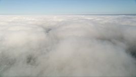 5K aerial stock footage fly over thick cloud cover beneath blue skies, California Aerial Stock Footage | AX0015_050