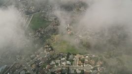 5K aerial stock footage of a bird's eye of residential neighborhoods through clouds, Oceanside, California Aerial Stock Footage | AX0015_052