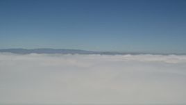 5K aerial stock footage of reverse view of thick cloud cover and blue skies, California Aerial Stock Footage | AX0016_002